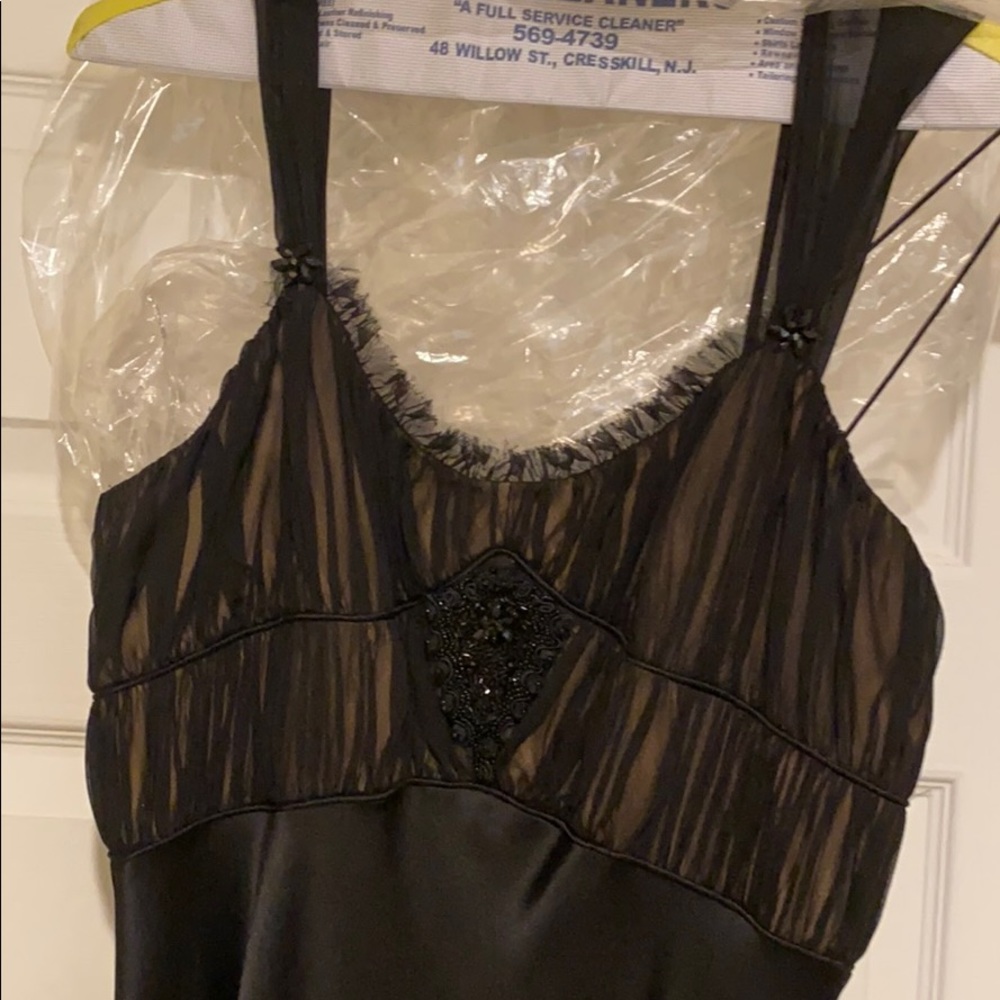 Satin evening gown with touched bust and beading.